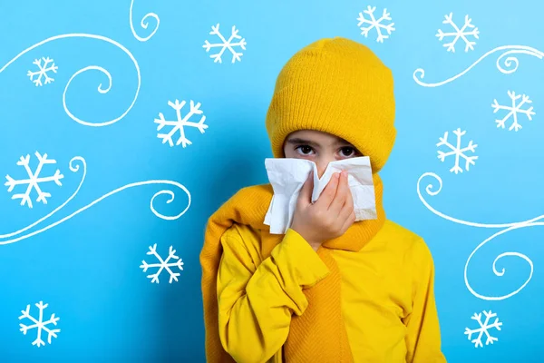 Child caught a cold and wipes her nose. Cyan background — Stock Photo, Image