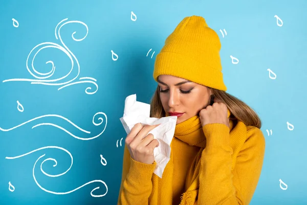 Girl caught a cold and wipes her nose. Cyan background — Stock Photo, Image