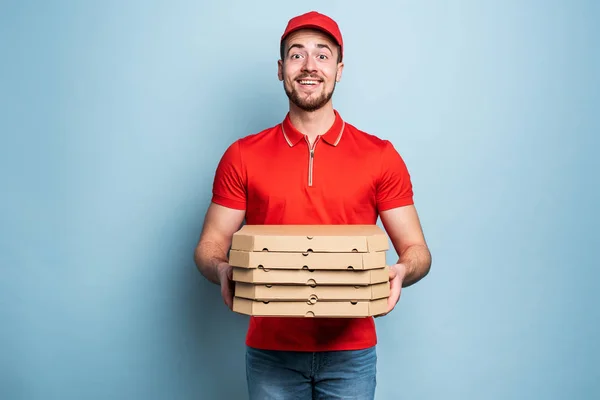 Zufriedene Lieferanten, die mit Erfolg Pizza ausliefern. Cyan-Hintergrund — Stockfoto