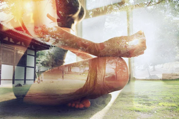 Young girl relaxing in yoga position in front of a bright window. Double exposure — 스톡 사진