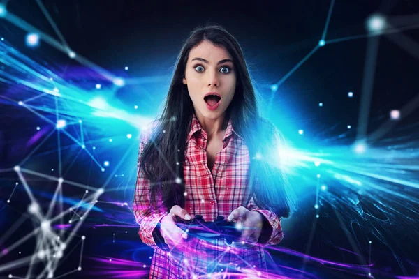 Shocked girl plays with online videogames. Concept of technology and entertainment — Stock Photo, Image