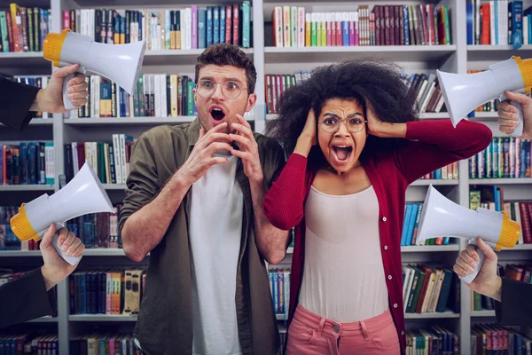 Student are worried and annoyed due to high volume of megaphone in a library — Stockfoto