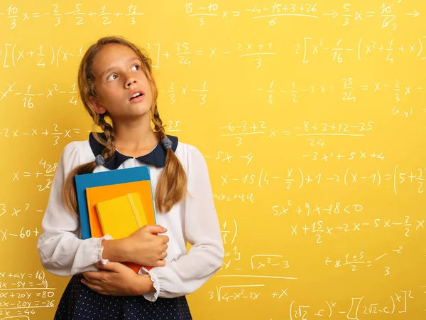 Young student is with shocked expression and think about complex exercises. Yellow background — Stok fotoğraf
