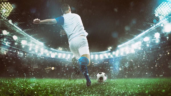 Gece bir futbol maçının kapanış sahnesinde beyaz ve mavi üniformalı bir oyuncu topa güçlükle vuruyor.