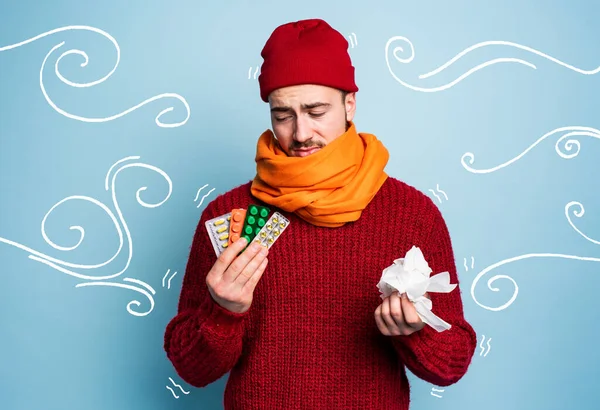 Boy caught a cold and uses pills to heal. Studio on Cyan background — Stock Photo, Image