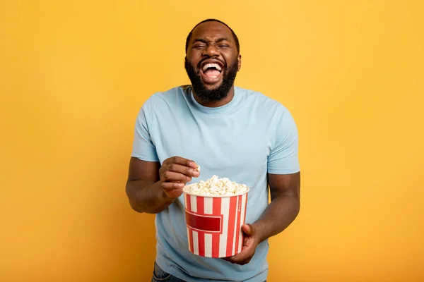 Boy has fun watching a film. Concept of entertainment and streaming tv. red background — Stock Photo, Image