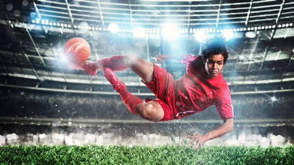 Football scene at night match with player kicking the ball with power. — Stock Photo, Image