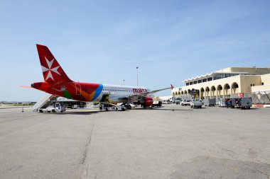 LUQA, MALTA - APRIL 18: The aircraft of Malta Airlines taking maintenance at Malta Airport on April 18, 2015 in Luqa, Malta. More then 1,6 mln tourists is expected to visit Malta in year 2015. clipart