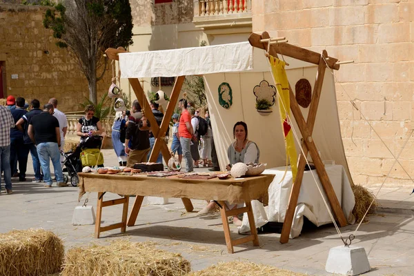 Mdina, Malta - 19 April: De vrouwen verkoopt souvenirs bij Mdina middeleeuws festival en toeristen op April 19, 2015 in Mdina, Malta. Meer dan 1,6 mln toeristen wordt verwacht voor een bezoek aan Malta in het jaar 2015. — Stockfoto