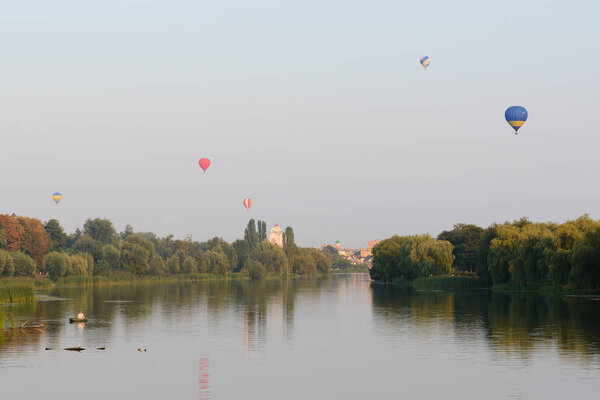 BILA TSERKVA, UKRAINE - AUGUST 26: The view on balloons are over Ros river in Bila Tserkva town on August 26, 2017 in Bila Tserkva, Ukraine. The balloons show is dedicated to Ukrainian Independence Day.
