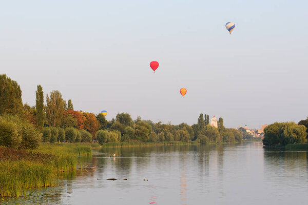 BILA TSERKVA, UKRAINE - AUGUST 26: The view on balloons are over Ros river in Bila Tserkva town on August 26, 2017 in Bila Tserkva, Ukraine. The balloons show is dedicated to Ukrainian Independence Day.
