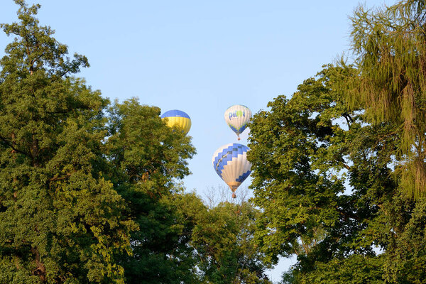 BILA TSERKVA, UKRAINE - AUGUST 27: The view on balloons are over  Olexandria Park and trees on August 27, 2017 in Bila Tserkva, Ukraine. The balloons show is dedicated to Ukrainian Independence Day.