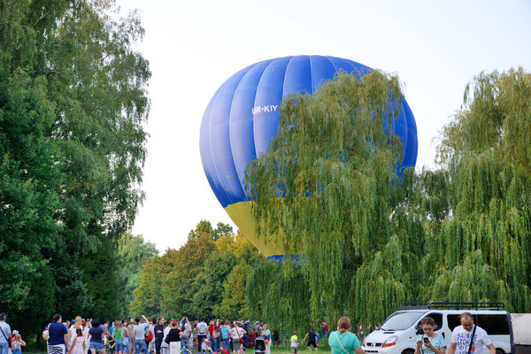 BILA TSERKVA, UKRAINE - AUGUST 26: The view on balloons are over  Olexandria Park and visitors on August 26, 2017 in Bila Tserkva, Ukraine. The balloons show is dedicated to Ukrainian Independence Day.
