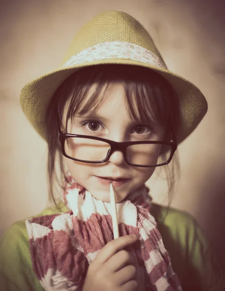 Little girl in hat and glasses. Stock Photo