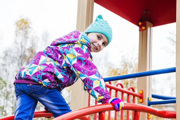 A menina está brincando de diversão no playground . — Fotografia de Stock