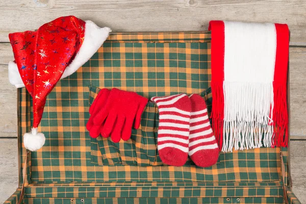 Christmas Santa Claus Caps och stickning remsor Golfs i öppna trä resväska. — Stockfoto