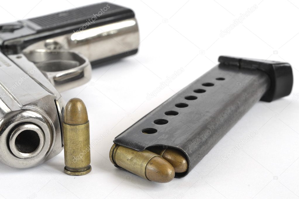 Pistol and ammunition on the white background