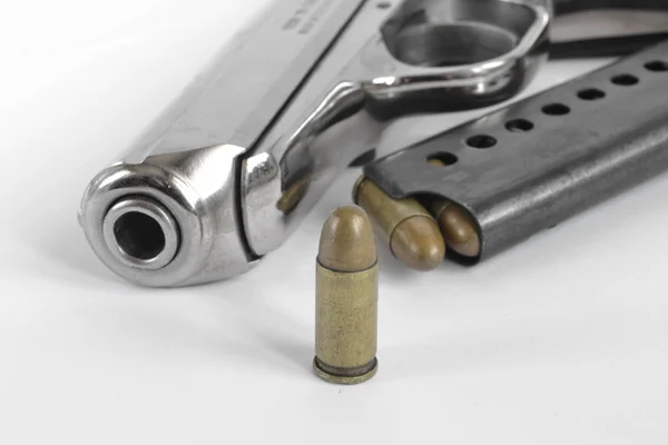 Pistol and ammunition on the white background Stock Photo