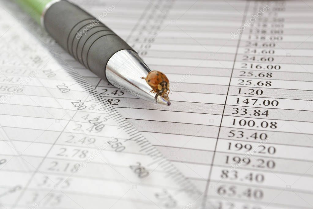 Business background with table, ruler, pen and beetle