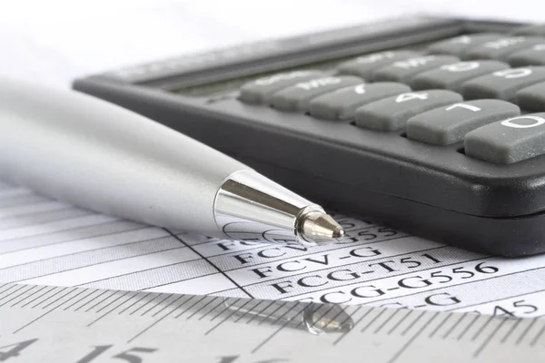 Business background with table, pen and calculator.