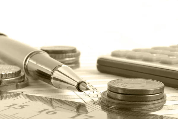 Financial background in sepia with money, calculator, ruler, table and pen.