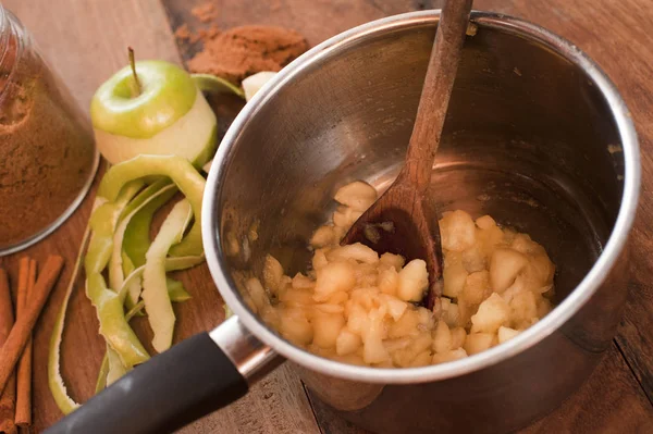 Cooking fresh diced apples to make a sauce