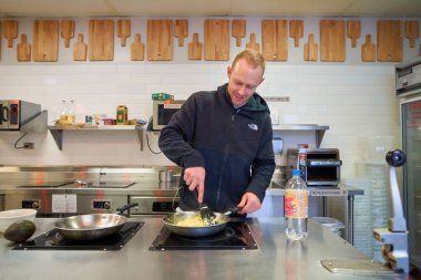 Chicago, Il, - Nisan, 2016 yaklaşık: adam Chicago Getaway Hostel yemek hazırlamak. Hosteller Konuklar genellikle bir ranza yatak, Çift Kişilik bir yatak nerede kiralayabilirsiniz bütçe odaklı, sosyal konaklama sağlamak.