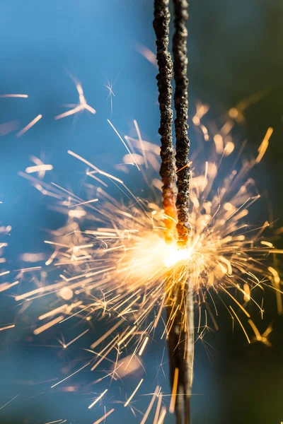 Sparks on a natural blue background — Stock Photo, Image