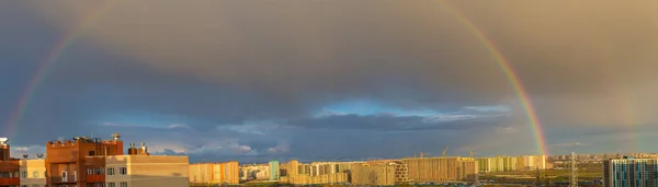 panorama of the morning rainbow over the city
