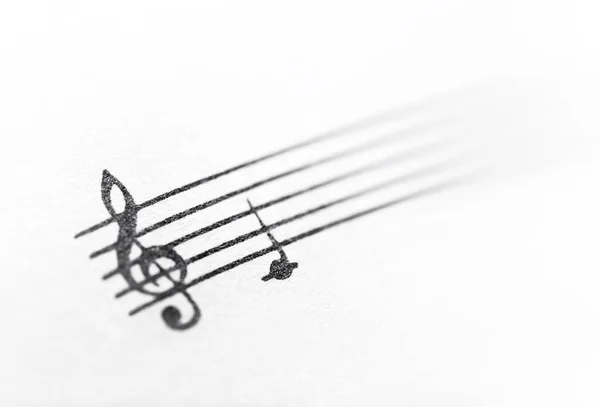 Clave triple y nota musical sobre papel —  Fotos de Stock