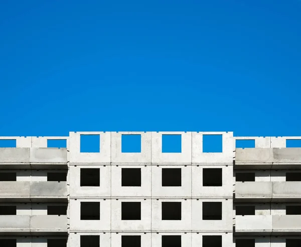 Fragment van een gebouw in aanbouw tegen een blauwe hemel. — Stockfoto