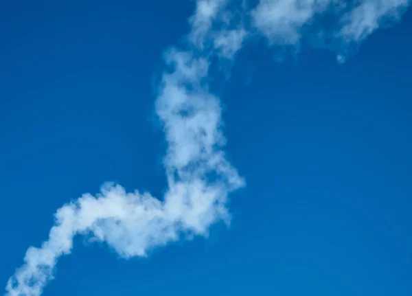 Smoke on blue sky background — Stock Photo, Image