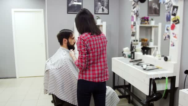 Barber cuts the hair of the client with scissors — Stock Video