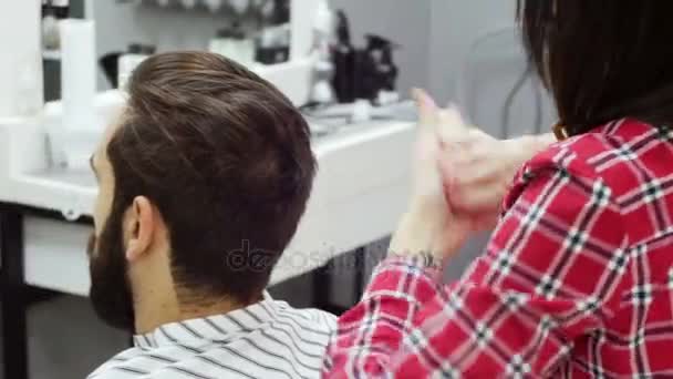 Barbeiro corta o cabelo do cliente com tesoura — Vídeo de Stock