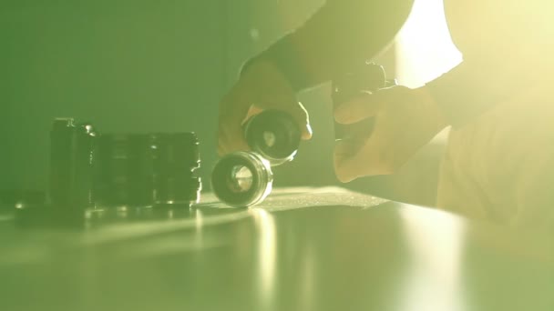 Fotógrafo Masculino Sosteniendo Lente Cámara Por Mesa Cambiando Lentes Iluminación — Vídeos de Stock