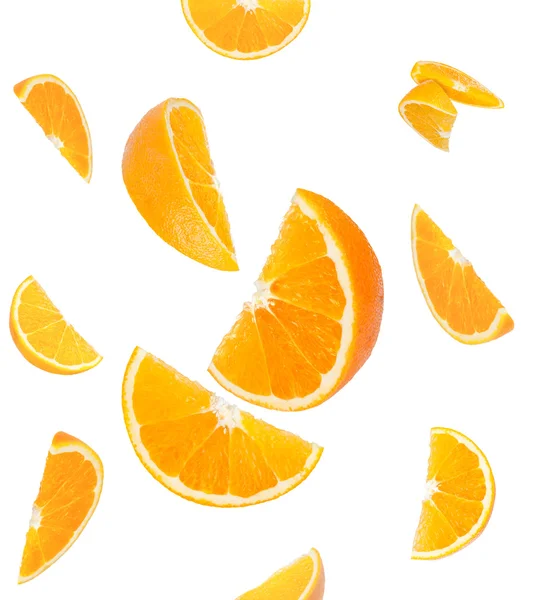Fatias de laranja e laranja em queda. Isolado sobre um fundo branco — Fotografia de Stock