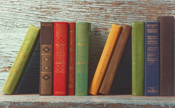 Old books on the background of a wooden — Stock Photo, Image
