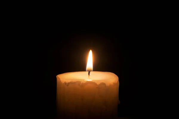 Brennende Kerze auf schwarzem Hintergrund — Stockfoto