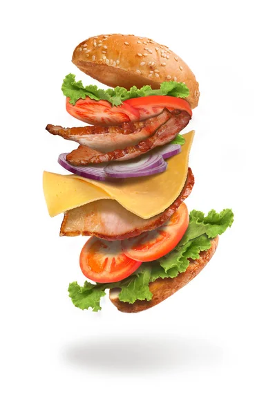 Smacznego hamburgera z latania składniki na białym tle na liczby biały — Zdjęcie stockowe