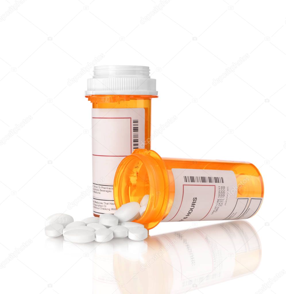 white pills in plastic yellow bottle isolated