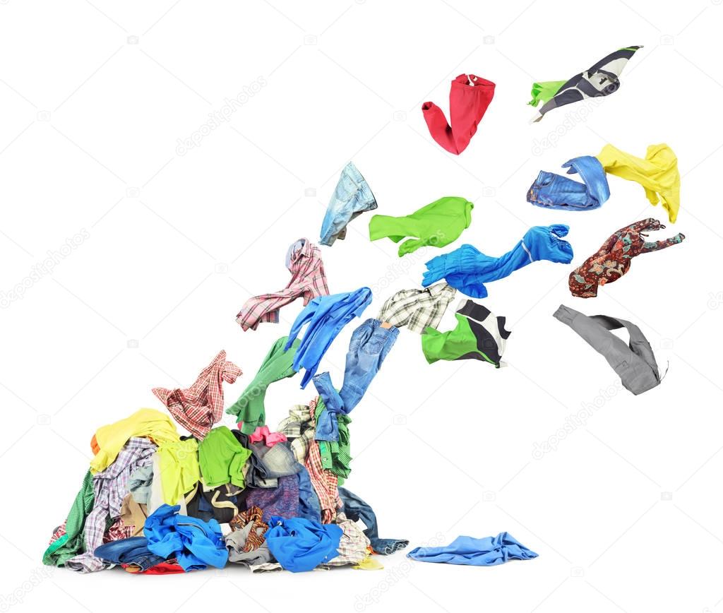Clothing flies from heap of clothes isolated on white background