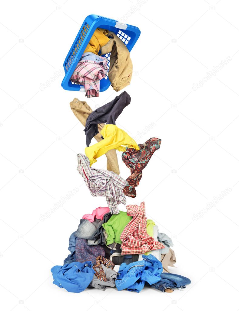 Clothes falling out of the basket in pile isolated on white back