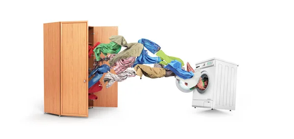 Одежда вылетает из шкафа в стиральную машину — стоковое фото