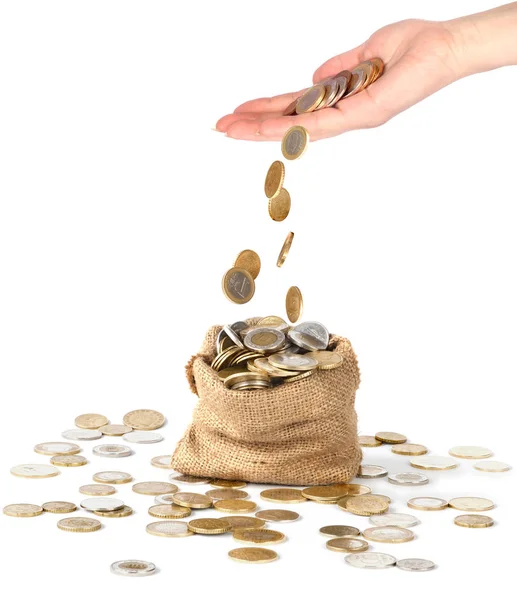 Coins drop from hand to bag — Stock Photo, Image