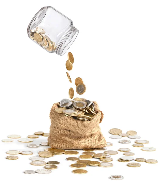 Mynt släppa från glasburken i påsen — Stockfoto
