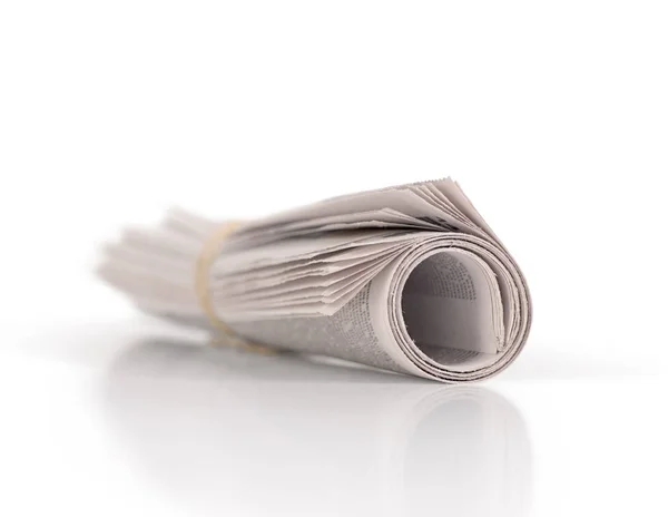 Rolled-up nnewspaper isolated on white background — Stock Photo, Image