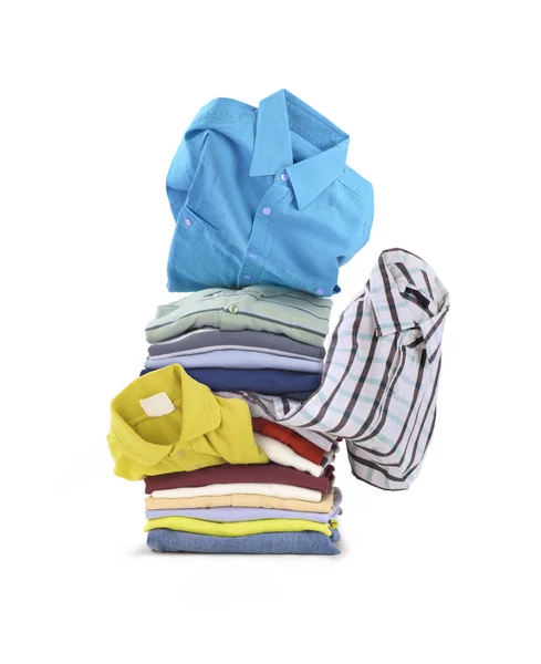 A stack of shirts.On a white background a stack of folded bright — Stock Photo, Image