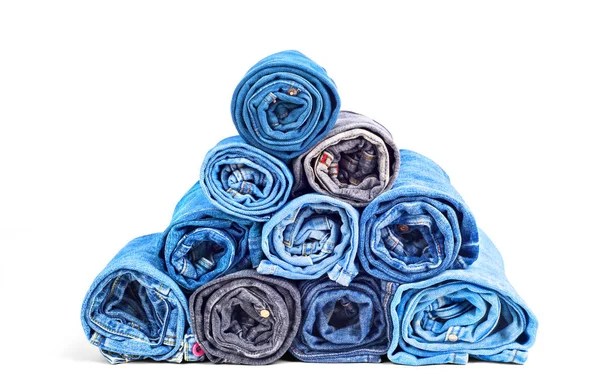Stack of twisted jeans isolated on a white background — Stock Photo, Image