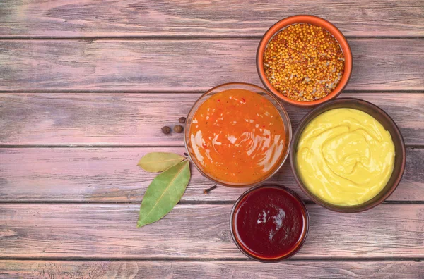 Sauces on a wooden background — Stock Photo, Image