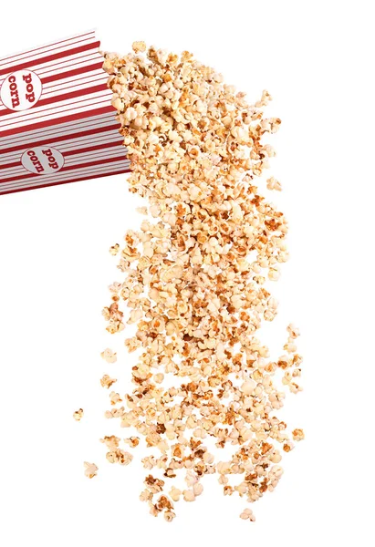 Popcorn strews from a paper cup on a white background — Stock Photo, Image